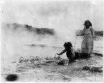 Maori women with kettles alongside hot springs