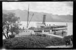 Passenger steamboat, 'Earnslaw', on Lake Wakatipu next to jetty, Queenstown, Otago