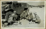 Artillery calibrating the guns; men enjoying a cup of morning tea in front of one of the quads - Photograph taken by an official photographer