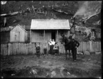 The Gate family outside their house, Tahora, Taranaki