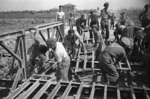 World War 2 New Zealand Engineers constructing a bridge over a canal near Budrio, Italy