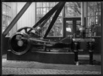 Petone Railway Workshops. Interior view of a workshop showing a stationary steam engine.