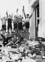 Seven school boys amongst the bottles they have collected as part of the local war effort