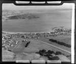The coastal settlement of Plimmerton and Saint Theresa's Church with State Highway 1 and Steyne Avenue with railway station, looking to Titahi Bay beyond, North Wellington Region