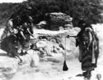 Maori women cooking food in a thermal spring at Rotorua