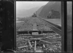 Ngauranga Railway Station; view of the station, railway track, and a class D locomotive in middle distance, ca 1900, taken from a work-train van.