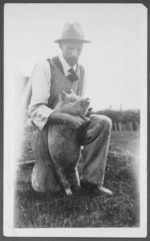 Photograph of Samuel Russell Feaver holding a pig