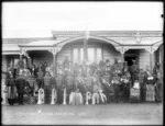 Members of a brass band, and others, outside the house of Charles Waitara, at Parihaka