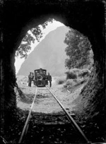 The Piha logging locomotive "Sandfly" framed by the Pararaha Tunnel mouth.