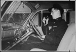 Traffic officer using his two-way radio inside a patrol car