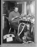Cecil H Meares making a dog harness during the British Antarctic Expedition of 1911-1913