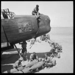Loading bombs into a Wellington bomber in Egypt during World War 2