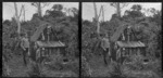 Edgar Williams standing beside a small hut, Pounawea, Catlins River