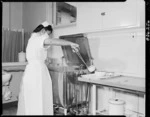 Norma Morehu removing utensils from a steriliser, Wellington Public Hospital - Photograph taken by T Ransfield