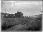 A steam train and locomotive on parallel railway lines, Maungaturoto.