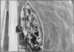 Wounded soldiers in stretchers being transferred to a hospital ship