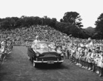 Queen Elizabeth the Queen Mother waves from an open car at a civic reception in Pukekura Park, New Plymouth