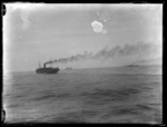 Three ships in transportation convoy at steam on the open sea