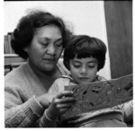 Helping daughter with reading; Knucklebones, Orakei Marae, Auckland