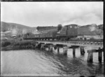 Train crossing a railway bridge over the Tokomairiro River at Waronui, Clutha District.