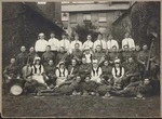 Group portrait of theatre performers in costume and military orchestra