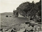 Creator unknown : Photograph of the Lake Waikaremoana shoreline, Wairoa district, showing Ship Rock