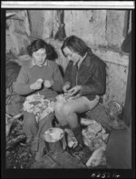 Trampers Naomi Power and Vera Morgan peeling vegetables, Tararua Range - Photograph taken by Barry Woods