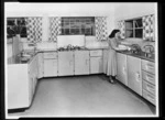 Kitchen interior with woman washing cup