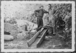 Gold miners Don Harvey and Joe Walker beside gold sluice, Golden Bay region