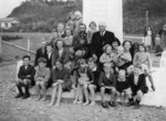 Pascoe, John Dobree, 1908-1972 :Photograph taken during the Tasman Tercentennial celebrations; shows Dr van der Plas, W H Parry, and children, at Tasman's memorial in Okarito, Westland