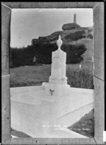 Monument to the Reverend Alexander Whyte, Presbyterian minister, with Captain Scott's cairn on the hill behind, at Port Chalmers