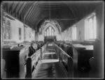 Interior view looking across stalls towards stained glass window, Christ's College chapel, Christchurch