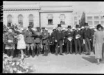 Men standing on street, military parade, Wellington