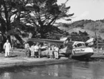 Locals by a Tourist Air Travel seaplane, Katherine Bay, Great Barrier Island - Photograph taken by G Reithmaier