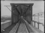 View along railway tracks and over bridge crossing the Whanganui River at Aramoho