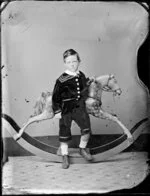 Unidentified boy with rocking horse