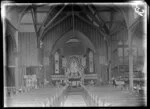 Interior of All Saint's Church, Ponsonby, Auckland, including organ, alter, stained glass windows, and pews