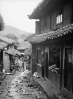 Yunnan, China. Lijiang; street with copper shops, September 1938.