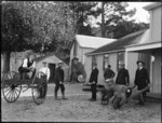 Group of men and beer barrels outside the Oaks Hotel, Mangonui