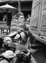 Yunnan, China. Tribes women doing laundry work, Lijiang, September 1938.