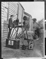 Member of the Salvation Army, possibly Joseph Perry, by a film projector