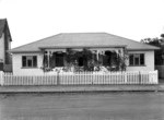 Karitane nurses home in Wanganui decorated with vegetation and flags