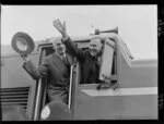 Prime Minister Holland and another official waving from the cabin on the first trip through the new Rimutaka Railway Tunnel