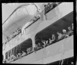 Passengers on board the ship Southern Cross as it prepares to depart from Wellington, including ticker-tape