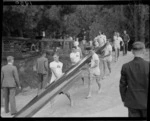 Australian men's eights team carrying boat to water, 1950 British Empire Games, Lake Karapiro