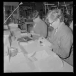 Two women cleaning leather brushes at the Tatra Leather factory, Wainuiomata