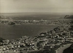 Creator unknown : Photograph of a view looking over Hataitai and Evans Bay, Wellington, towards Kilbirnie, Rongotai, and Lyall Bay