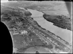 A view of Huntly township and industrial works in the foreground on the right, showing Waikato River on the left