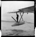 Working on the damaged float of TEAL Solent flying boat Ararangi, Evans Bay