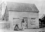 Two Maori women outside the Church of England parsonage, Greytown